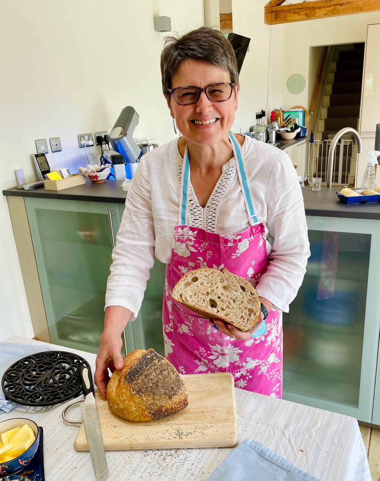 Kate from Bramble Bakes holding a freshly baked sourdough loaf
